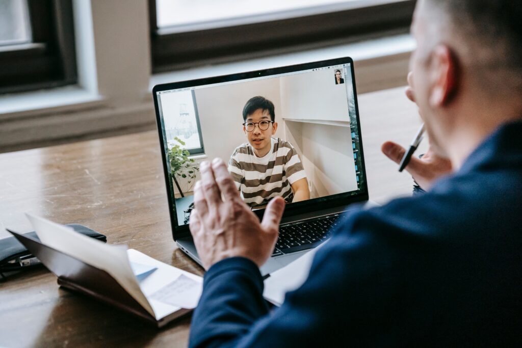 Hiring manager conducting a video interview with a candidate on a laptop